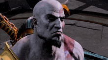 a bald man with a beard and a cross on his forehead