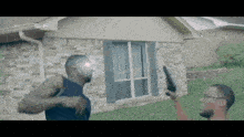 a man holding a gun in front of a house