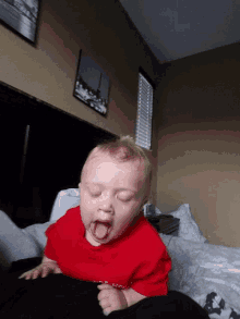 a baby wearing a red shirt that says ufc on it