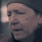 a close up of a woman 's face wearing a hat .