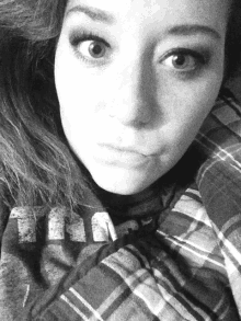 a black and white photo of a woman laying on a bed