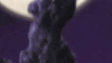 a close up of a person holding a purple flower in front of a full moon .