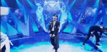 a man in a suit is dancing on a stage in front of a tiger statue .