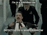 a man in a wheelbarrow is being escorted by two police officers