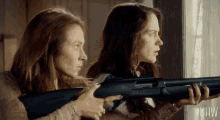 two women are holding guns in front of a window and the word hw is on the bottom