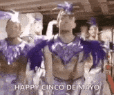 a man in a purple costume is dancing in front of a crowd .