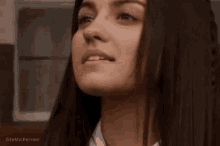 a close up of a woman 's face with the words sitemalperroni at the bottom .