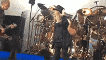 a man is playing a guitar and a child is playing a trumpet on stage .