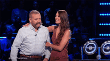a man with a mustache and a woman standing next to each other on a show called nbc the wall