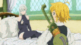 a man is sitting on a bed next to a woman who is sitting on a bed