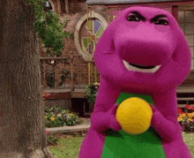 a purple dinosaur is holding a yellow ball in its hands .