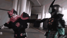 a man in a red and black costume is kicking another man in a black and green costume