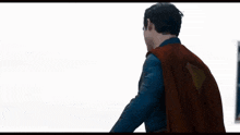 a man wearing a red cape with a yellow triangle on the back
