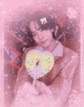 a young man holding a heart shaped lollipop with the word peace on the bottom