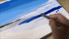 a person is painting a picture of a beach with the words wow art below it