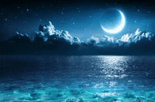 a crescent moon is reflected in the water of the ocean at night .