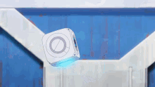 a white box with a blue light on it is floating in the air