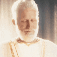 a man with a white beard and a white robe