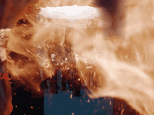 a group of people are standing in front of a wall of flames with the word jesus on it