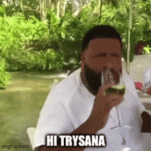 a man with a beard is drinking a glass of wine and says hi trysana .
