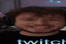 a man with a beard wearing headphones and a shirt that says twitch on it