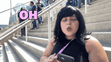a woman standing on a set of stairs with the word oh written above her