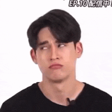 a young man is making a funny face with his eyes closed .