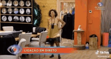 a woman is standing in a room with her hands on her hips and a sign that says tik tok .