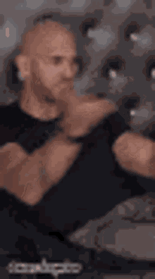 a man wearing a black shirt with the word slap on it .