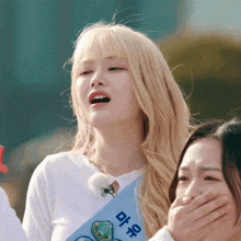 a girl with blonde hair is wearing a blue sash that says ' cycling ' on it