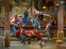 a group of people are dancing in a room with a sign that says ' no smoking '