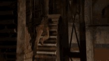 a man is hanging from a rope in a room