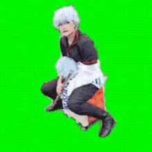 a person is riding another person on their back on a green background .