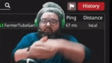 a man wearing headphones and glasses is making a funny face in front of a history button .