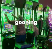 a group of people are playing a slot machine and the word gooning is on the screen