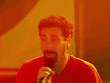a man singing into a microphone with a beard