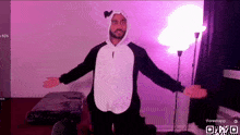 a man in a panda costume is standing in front of a lamp