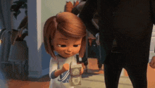a little girl is holding a bunch of money in her hands