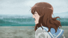 a girl with brown hair is wearing a sailor uniform with the letter x on the collar