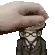 a hand is putting a hat on top of a man in a suit and tie .