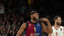 a basketball player is standing next to another player during a game .
