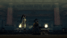 a man with a sword stands next to another man
