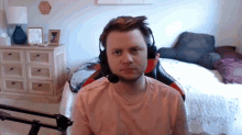 a man wearing headphones and a headset looks at the camera