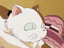 a white and brown cat with green eyes laying down