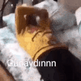 a person is laying on a bed with the word günaydinnn written on the bottom