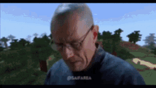 a man wearing glasses is standing in front of a minecraft world .
