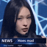 a woman is standing in front of a news screen that says news hoes mad