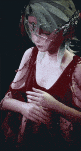 a woman wearing a red dress and a mask