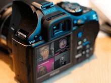 a pentax camera has a screen that shows an entrepreneur talks