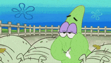 a green cartoon character with purple eyes and a purple nose